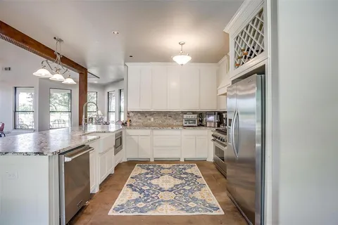 a kitchen with a stove and a wooden floors