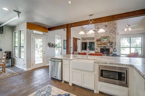 a bedroom with furniture and a large window