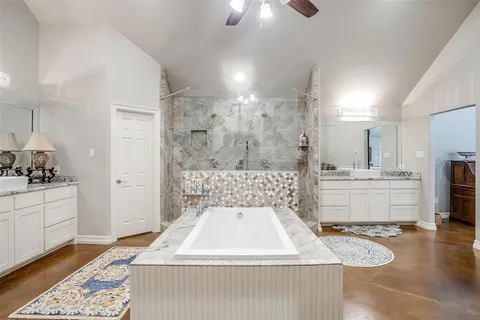 a bathroom with a sink a toilet tub and shower