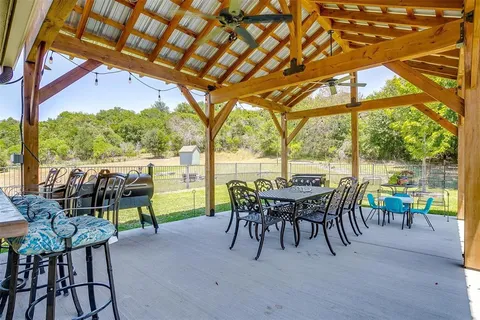 a view of a patio with table and chairs and potted plants