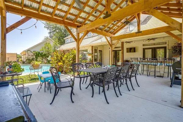 a view of a house with swimming pool and sitting area