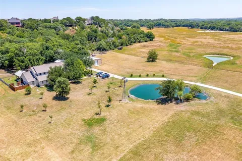 a view of a small house with wooden fence