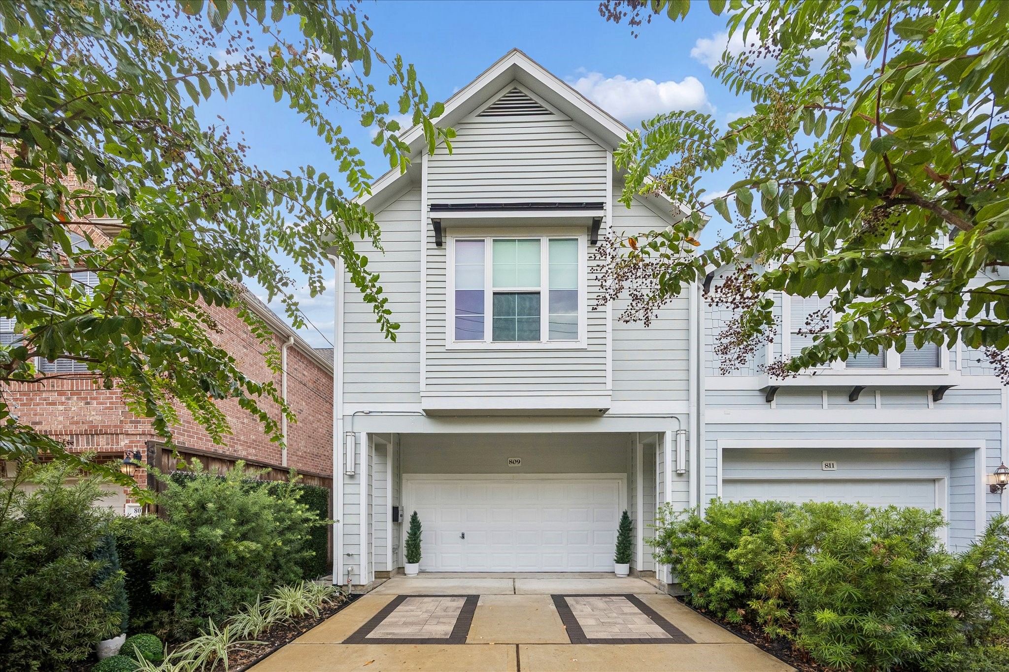 809 Malone Street Houston, TX 77007 - Photo 1 of 26 Inviting front elevation framed by mature landscaping and trees.