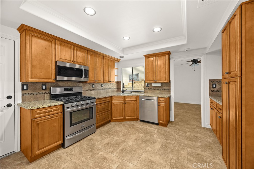 9862 Solazzo Drive Rancho Cucamonga, CA 91730 - Photo 13 of 30 a kitchen with a sink stove and refrigerator