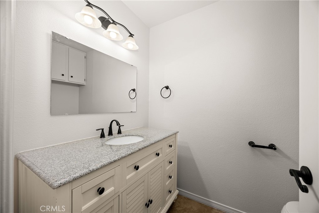 9862 Solazzo Drive Rancho Cucamonga, CA 91730 - Photo 16 of 30 a bathroom with a granite countertop sink and a mirror