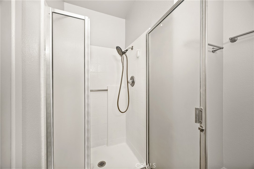 9862 Solazzo Drive Rancho Cucamonga, CA 91730 - Photo 27 of 30 a bathroom with a glass shower door