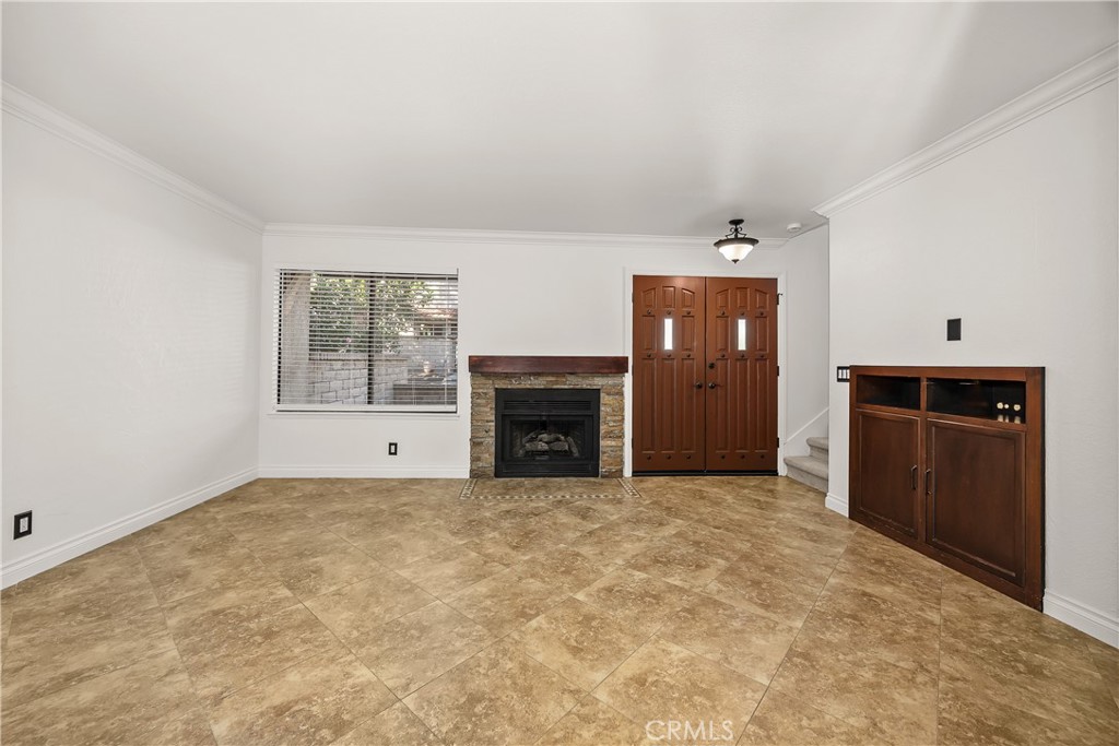 9862 Solazzo Drive Rancho Cucamonga, CA 91730 - Photo 8 of 30 an empty room with windows and fireplace
