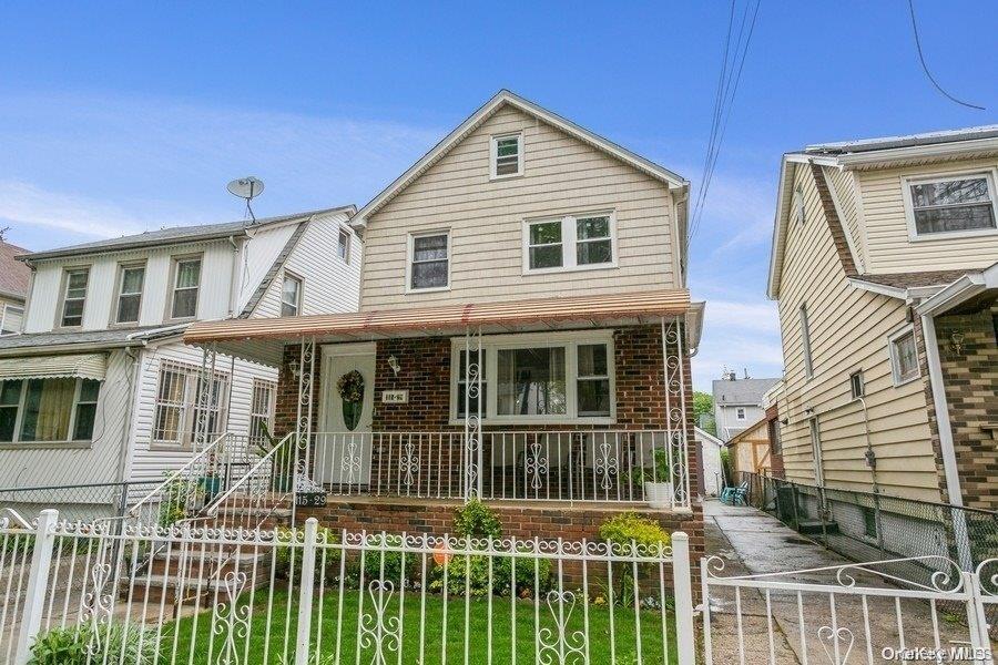 115-29 198th Street, Unit 1 Queens, NY 11412 - Photo 2 of 12 a front view of a house with a porch