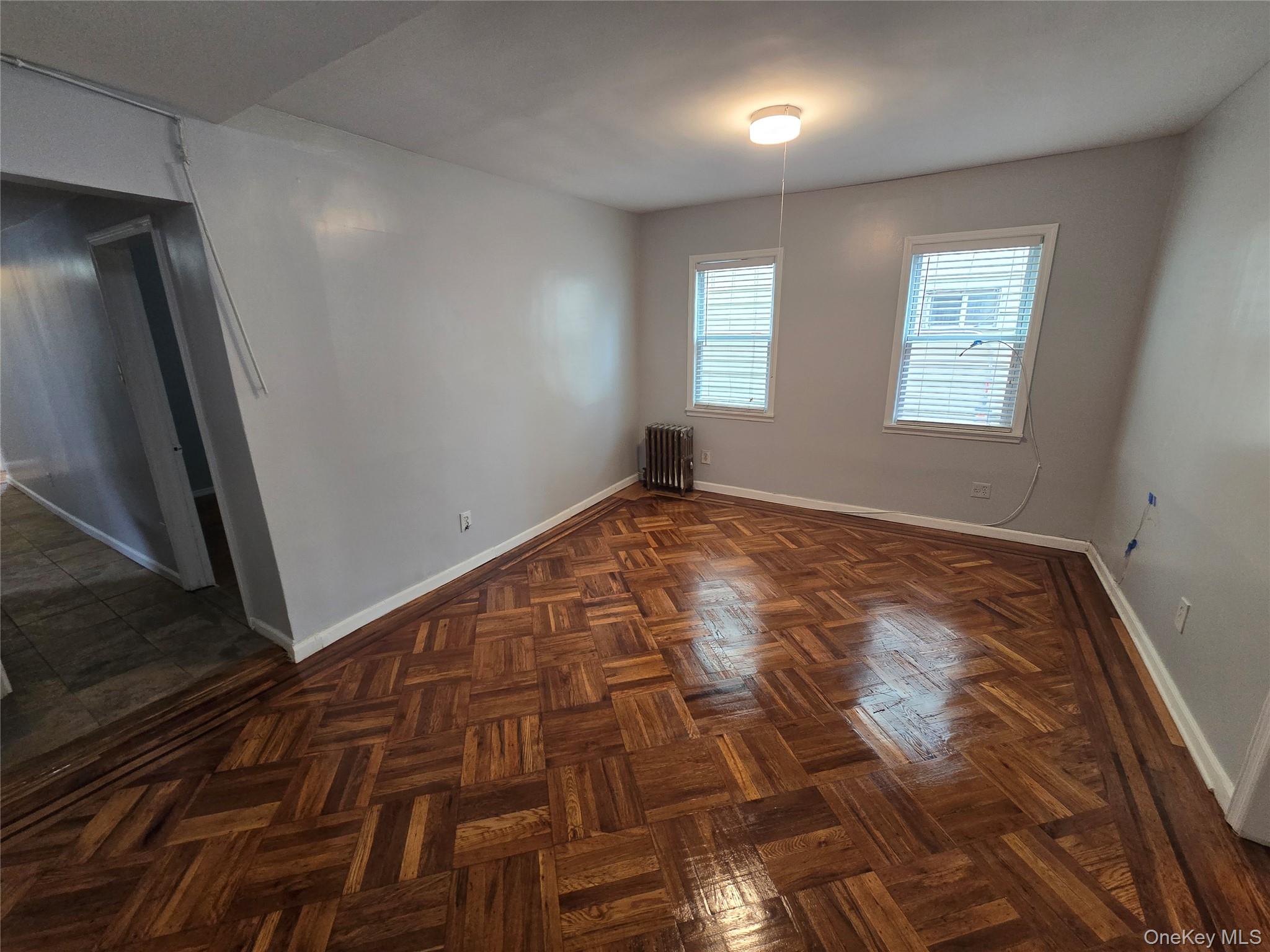 115-29 198th Street, Unit 1 Queens, NY 11412 - Photo 4 of 12 a view of an empty room and window