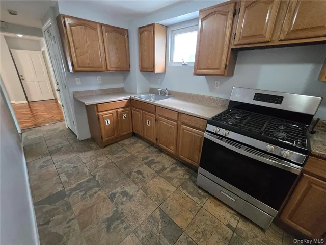a kitchen with a stove microwave and sink