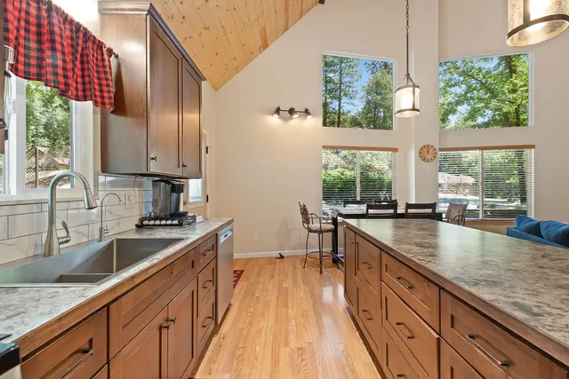 a kitchen with stainless steel appliances granite countertop sink stove and cabinets