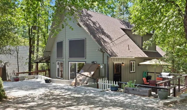 a view of a house with backyard porch and sitting area