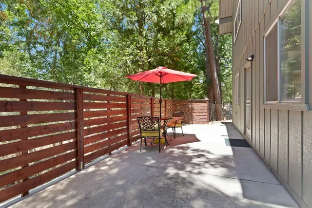 a view of a patio with a table and chairs under an umbrella