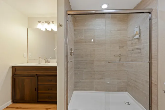 a bathroom with a shower and a sink