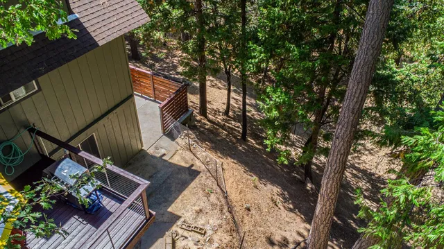 a balcony with wooden floor and some trees