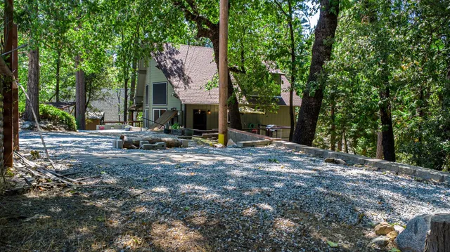a backyard of a house with oven and large trees