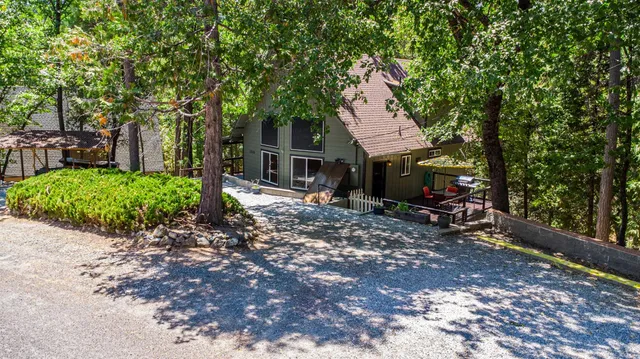 a view of a patio with table and chairs under an umbrella