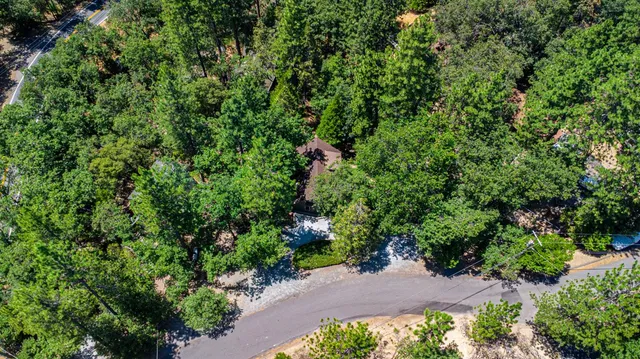 an aerial view of a house with a yard