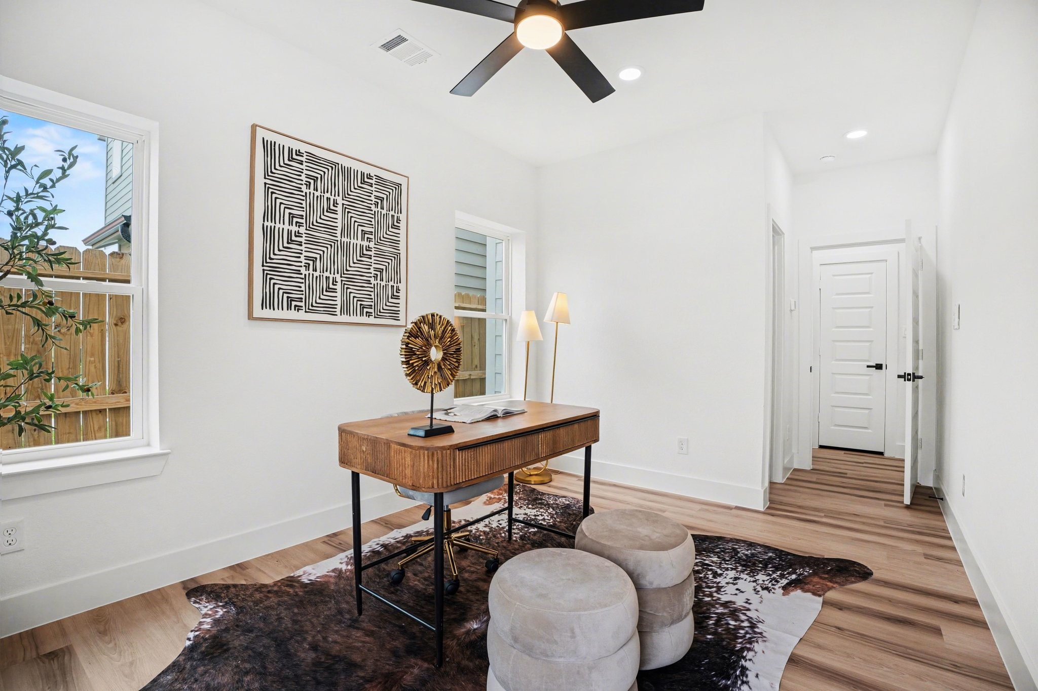 115 Milby Street Houston, TX 77003 - Photo 19 of 28 This bright, modern home office (or secondary bedroom) features large windows, a glass door for natural light, and a full walk-in close, and bathroom.