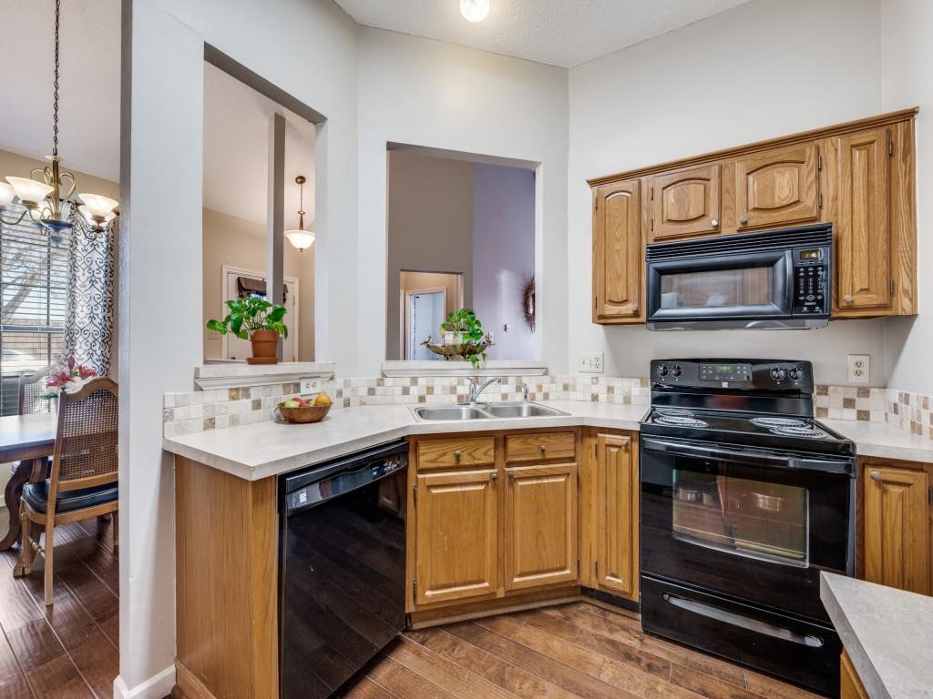 4321 Harvest Hill Road Carrollton, TX 75010 - Photo 13 of 25 a kitchen with a sink and stove top oven