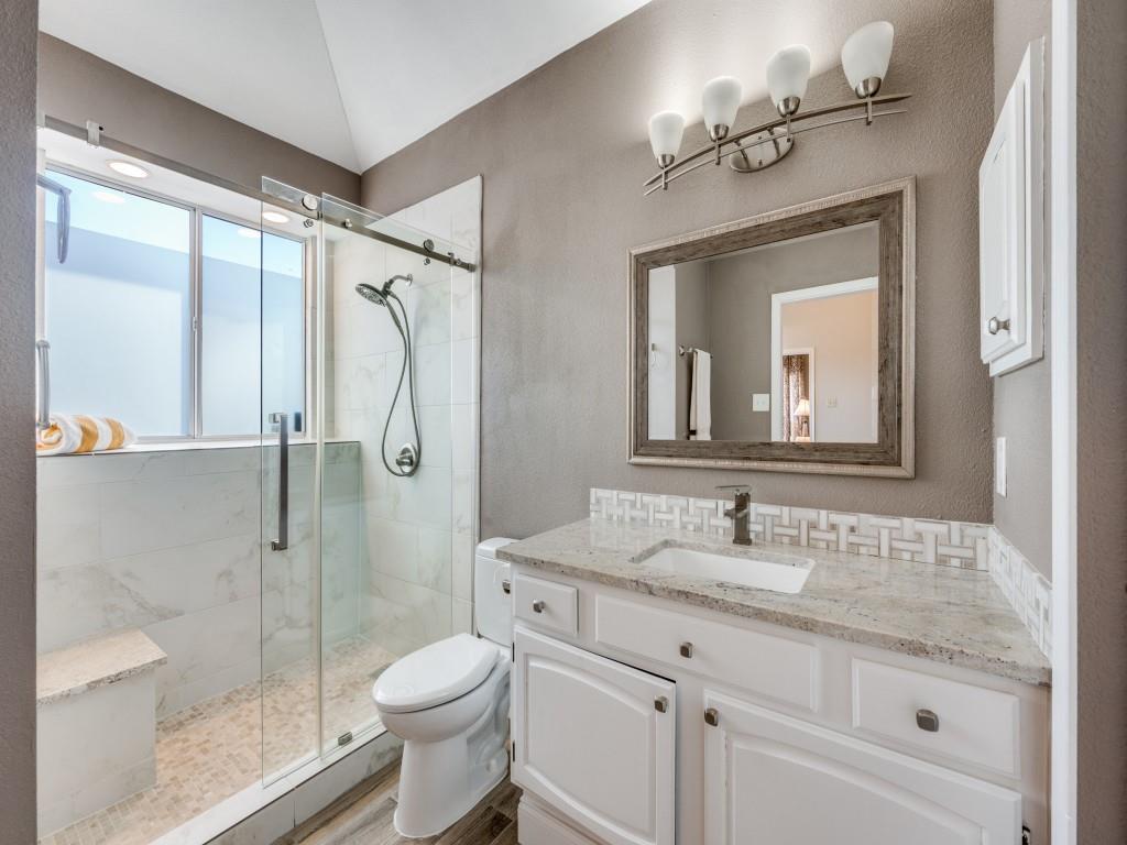 4321 Harvest Hill Road Carrollton, TX 75010 - Photo 18 of 25 a bathroom with a granite countertop toilet sink and shower