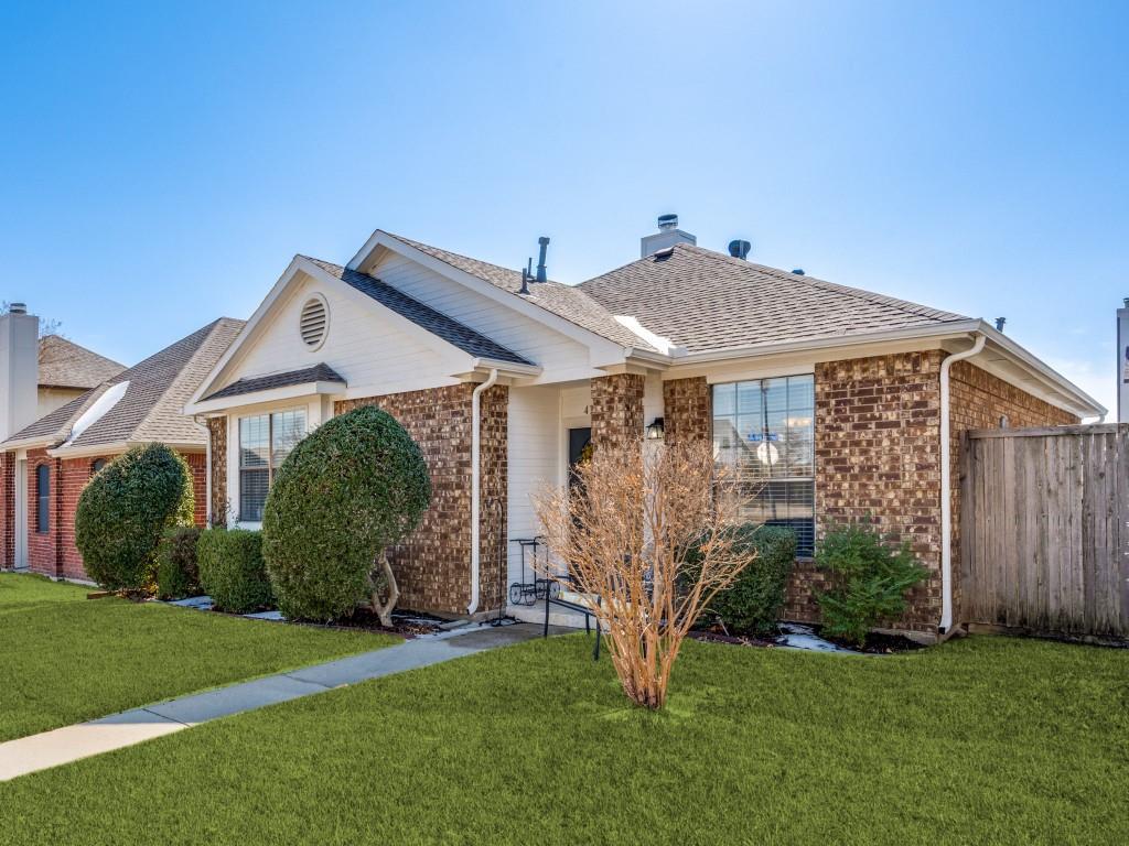4321 Harvest Hill Road Carrollton, TX 75010 - Photo 2 of 25 a front view of a house with a garden