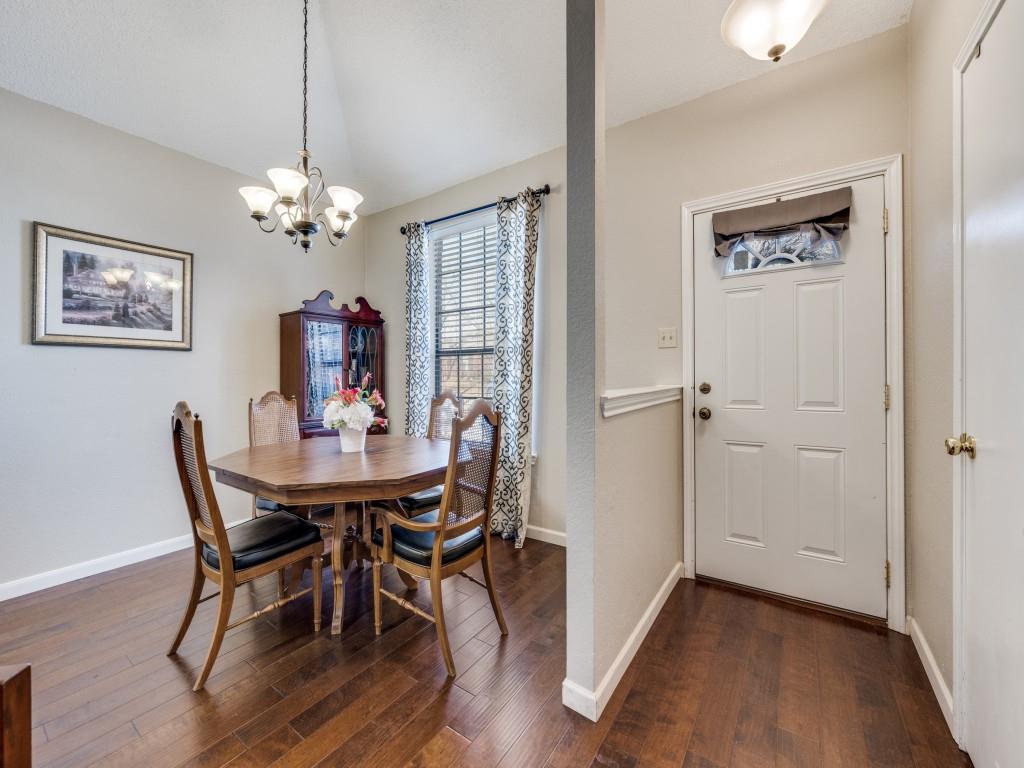 4321 Harvest Hill Road Carrollton, TX 75010 - Photo 4 of 25 a view of a dining room with furniture a chandelier and wooden floor