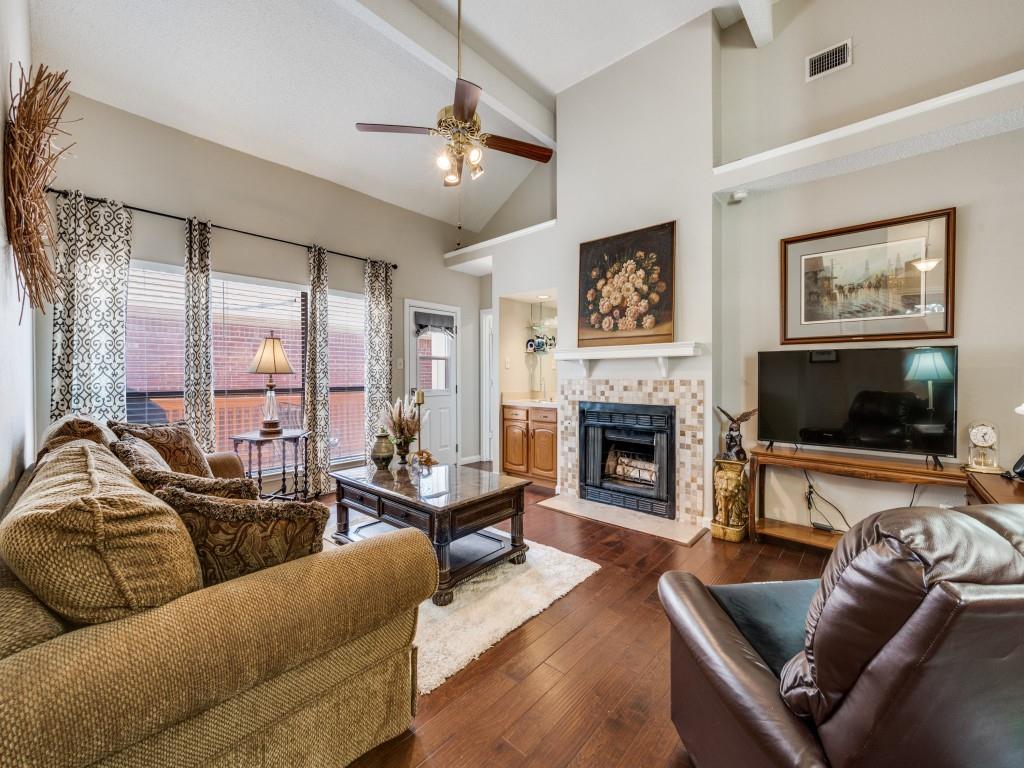 4321 Harvest Hill Road Carrollton, TX 75010 - Photo 7 of 25 a living room with furniture flat screen tv and a fireplace
