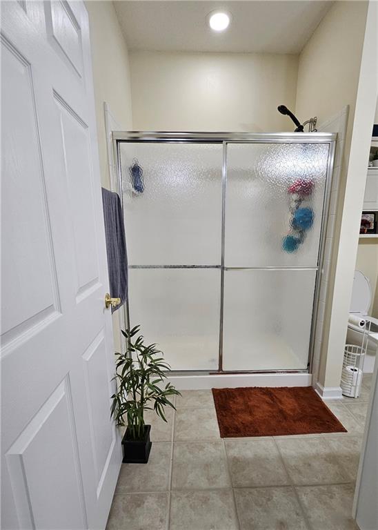 112 Camry Lane Southwest Grayson, GA 30017 - Photo 11 of 15 a vase of flowers sitting on a floor in a bathroom