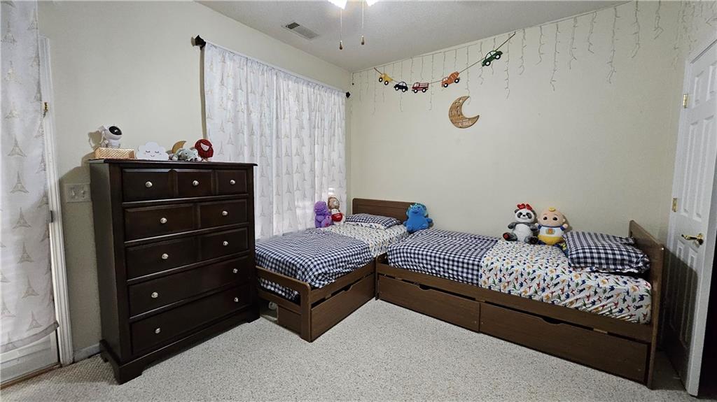 112 Camry Lane Southwest Grayson, GA 30017 - Photo 14 of 15 a bedroom with a bed and a dresser