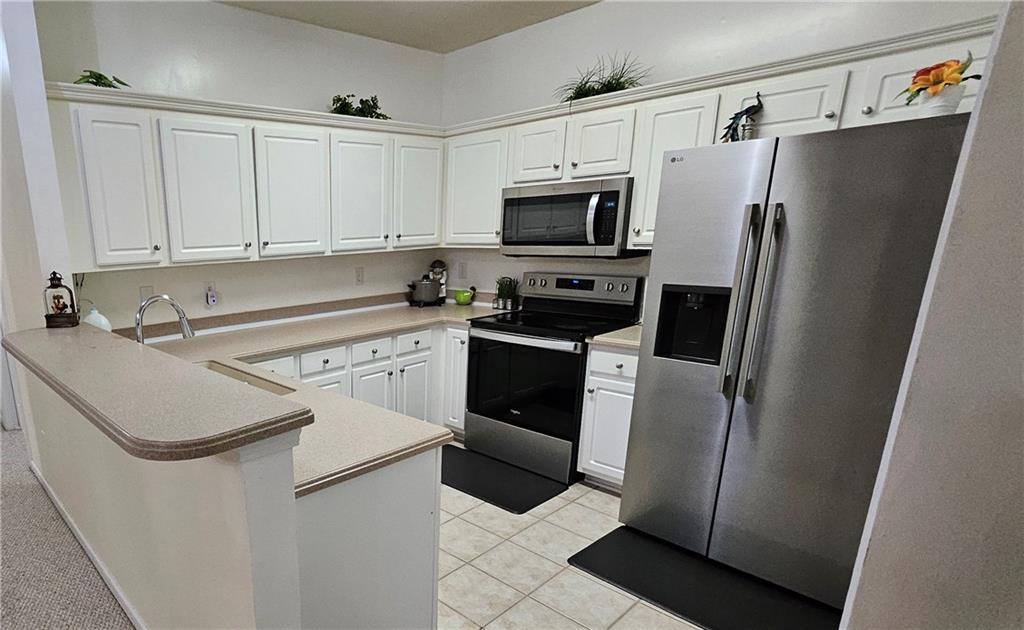 112 Camry Lane Southwest Grayson, GA 30017 - Photo 7 of 15 a white refrigerator freezer sitting inside of a kitchen