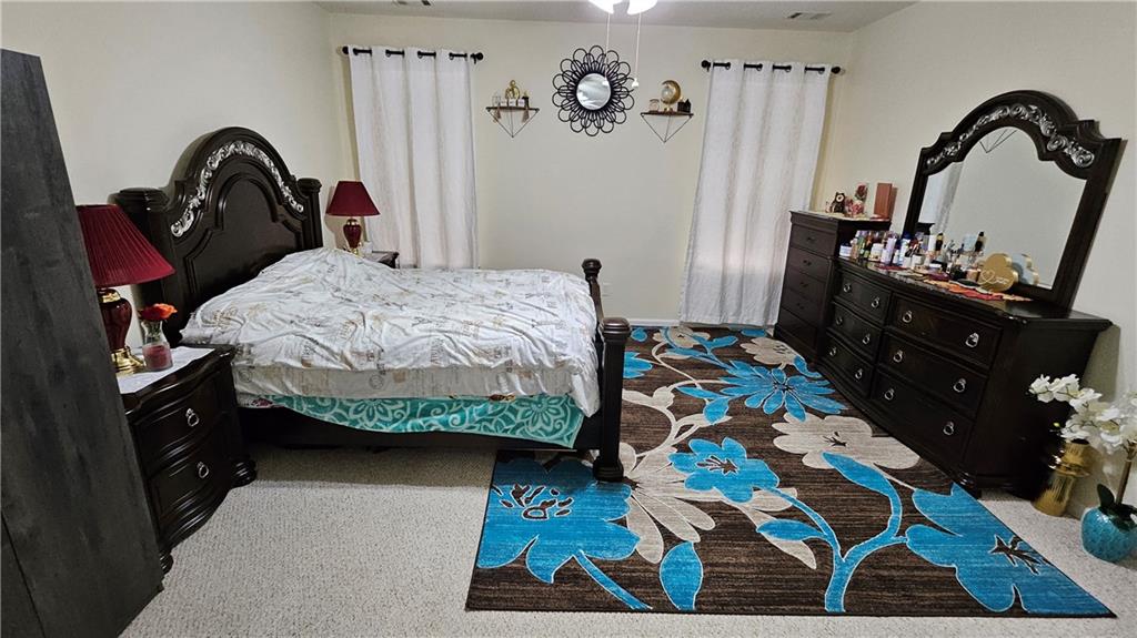 112 Camry Lane Southwest Grayson, GA 30017 - Photo 8 of 15 a bedroom with a bed and dresser