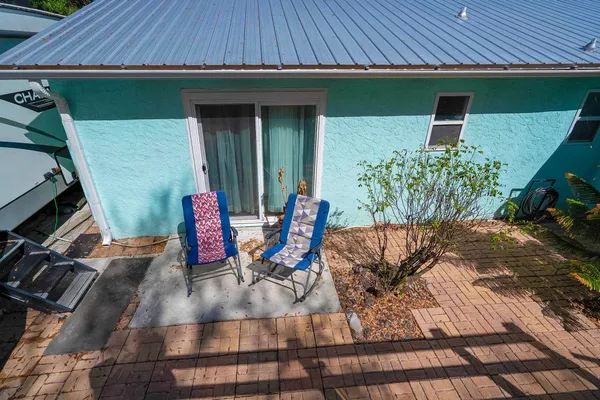 a front view of a house with a yard and tree