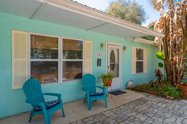 a hallway with a dining table and chairs