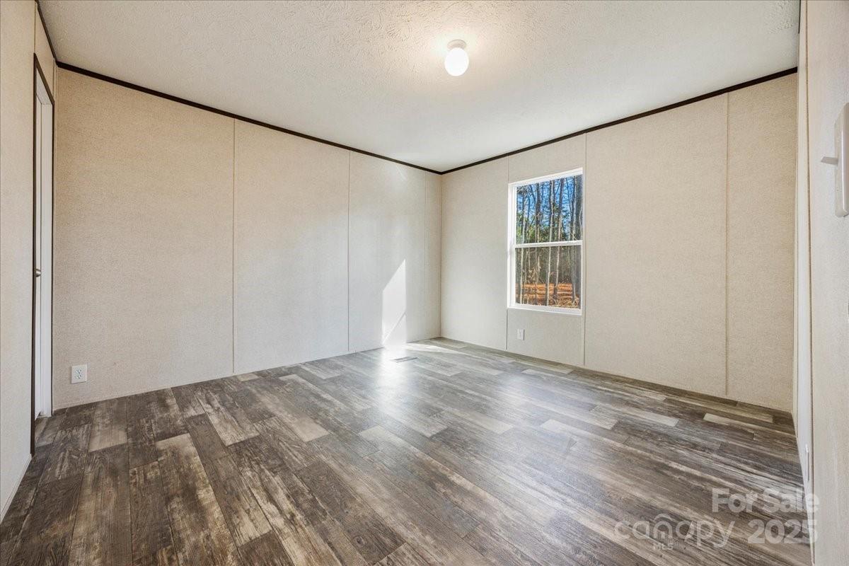 1381 Safrit Road Salisbury, NC 28146 - Photo 14 of 19 an empty room with wooden floor and windows