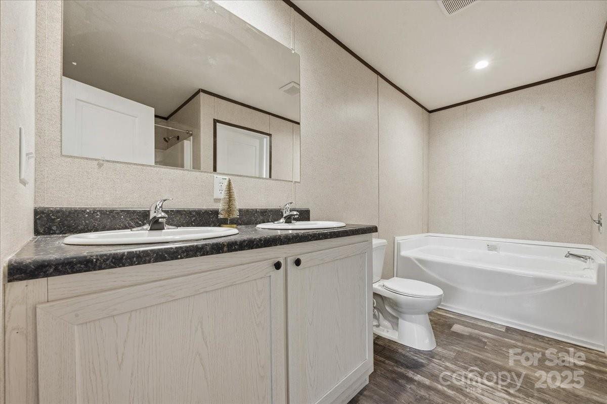 1381 Safrit Road Salisbury, NC 28146 - Photo 16 of 19 a bathroom with a granite countertop sink a toilet and bathtub