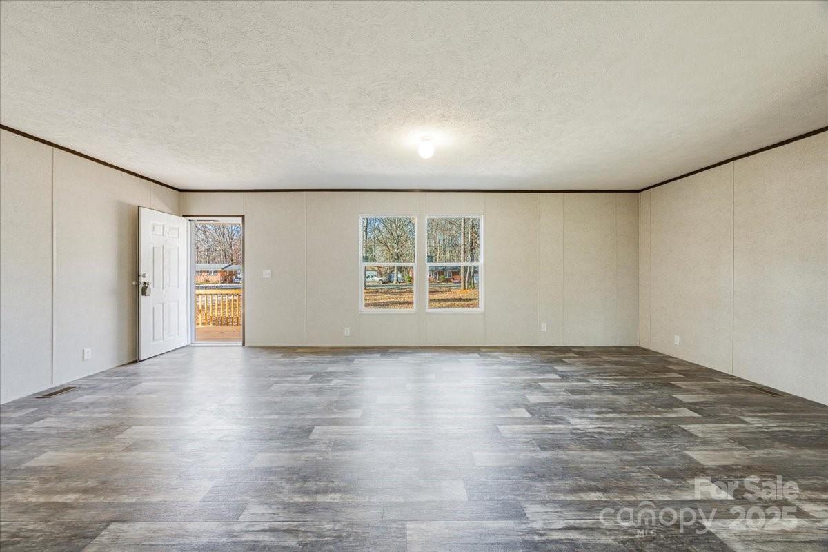 1381 Safrit Road Salisbury, NC 28146 - Photo 6 of 19 an empty room with wooden floor and windows