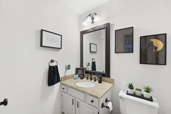 a bathroom with a toilet sink and mirror