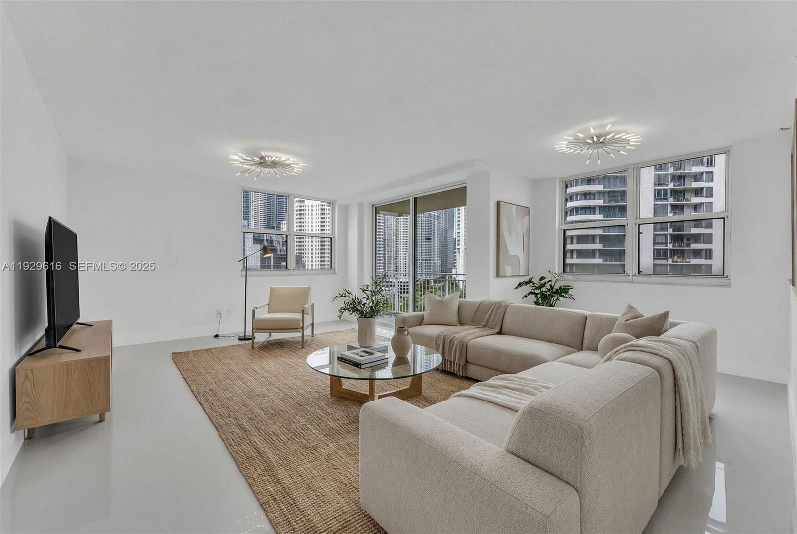 770 Claughton Island Drive, Unit 1401 Miami, FL 33131 - Photo 29 of 31 a living room with fireplace furniture and a flat screen tv