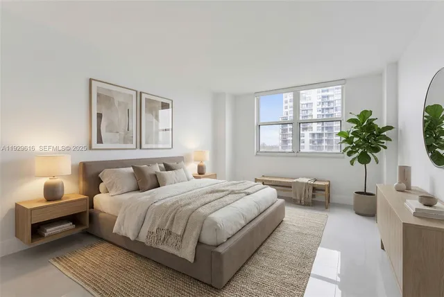 a bedroom with a large bed and a potted plant