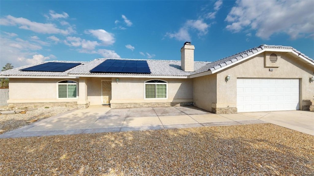 12403 Snapping Turtle Road Apple Valley, CA 92308 - Photo 1 of 1 a front view of a house with a yard and garage