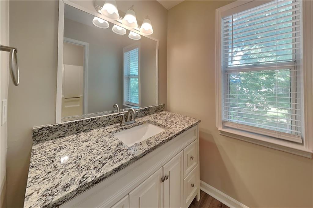 335 Olde Bridge Way Johns Creek, GA 30022 - Photo 9 of 19 a bathroom with a granite countertop sink and a mirror