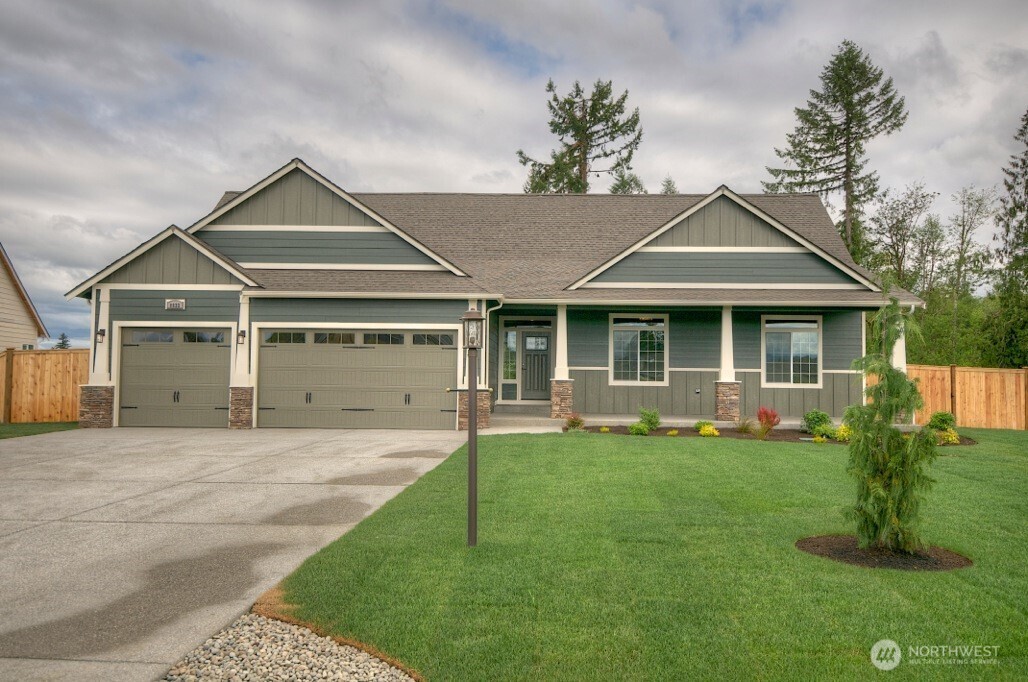 14443 Mima Road Southwest Olympia, WA 98512 - Photo 1 of 38 a front view of a house with a yard and porch