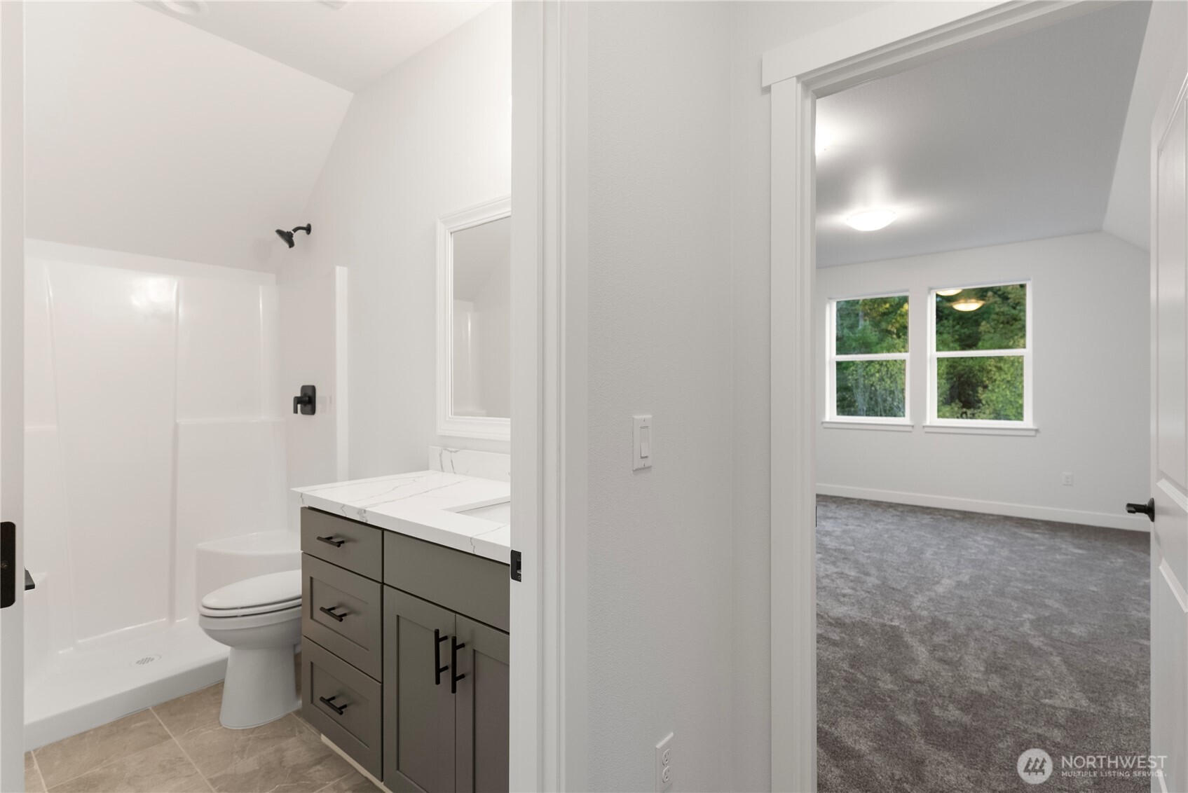 14443 Mima Road Southwest Olympia, WA 98512 - Photo 18 of 38 a bathroom with a granite countertop sink a toilet a mirror and shower