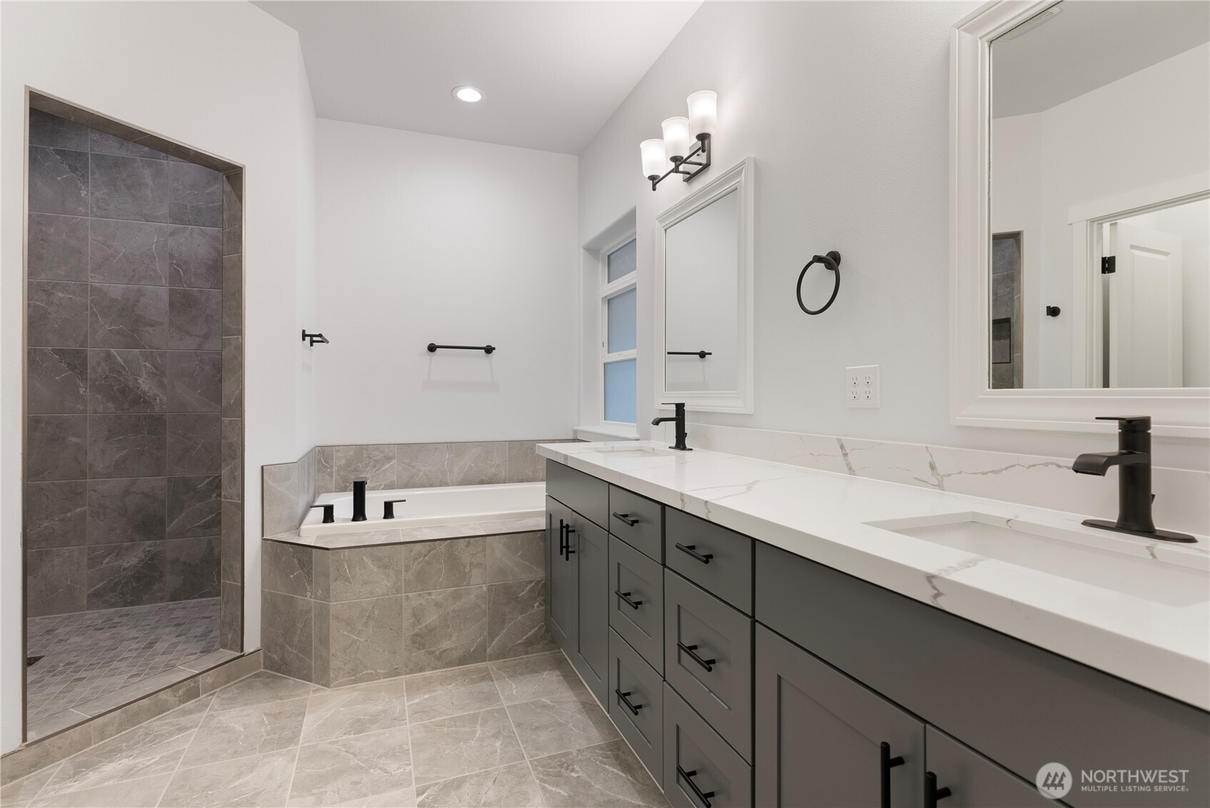 14443 Mima Road Southwest Olympia, WA 98512 - Photo 34 of 38 a spacious bathroom with a tub sink and mirror