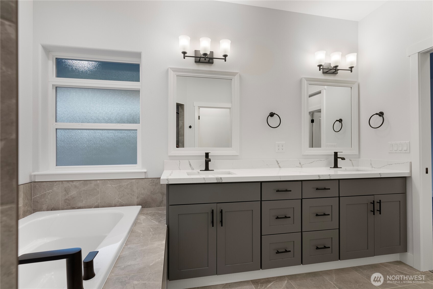 14443 Mima Road Southwest Olympia, WA 98512 - Photo 37 of 38 a bathroom with a tub double sink and mirror