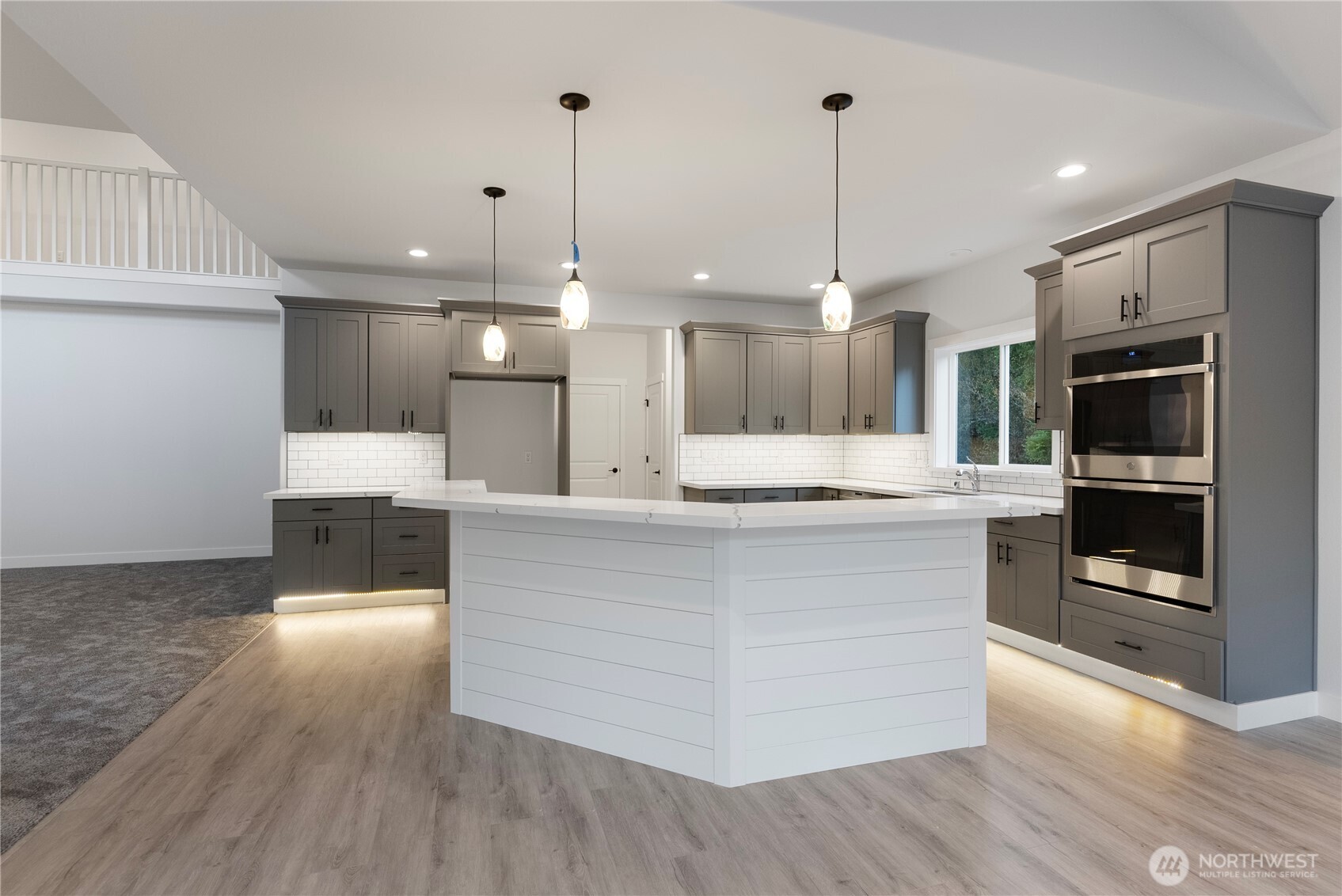14443 Mima Road Southwest Olympia, WA 98512 - Photo 9 of 38 a large kitchen with stainless steel appliances kitchen island a large island in the center