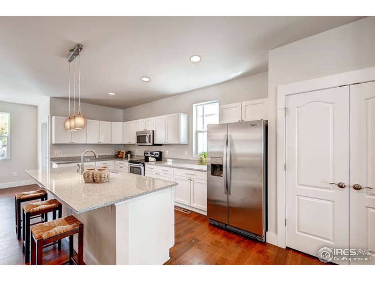 808 East Baseline Road, Unit B Lafayette, CO 80026 - Photo 2 of 9 a kitchen with refrigerator cabinets and wooden floor