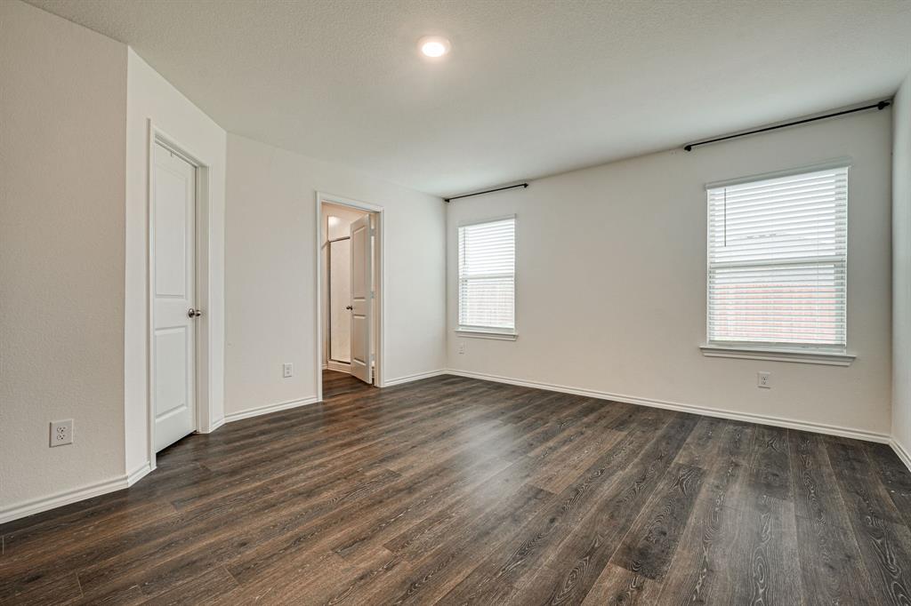317 Sage Street Anna, TX 75409 - Photo 14 of 33 an empty room with wooden floor and windows