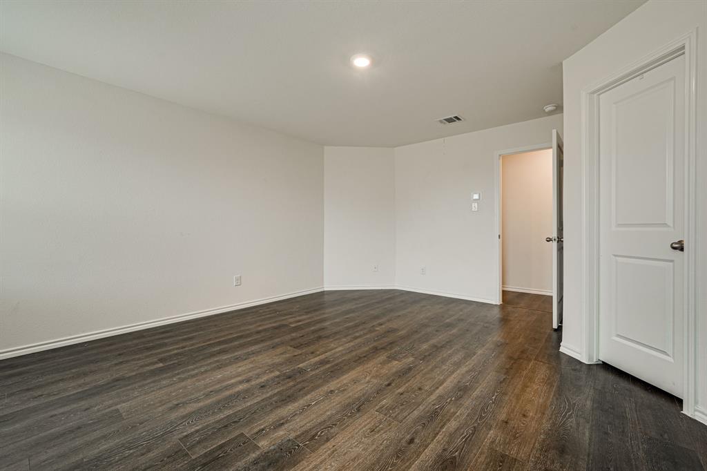 317 Sage Street Anna, TX 75409 - Photo 15 of 33 a view of an empty room with wooden floor